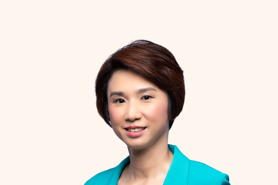 Senior Minister of State Low Yen Ling in teal blazer, smiling against light background.